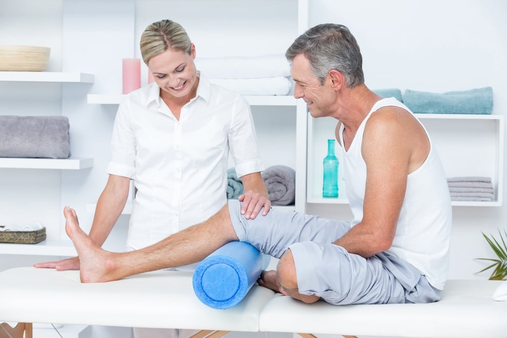 Doctor examining her patient leg in medical office.jpeg