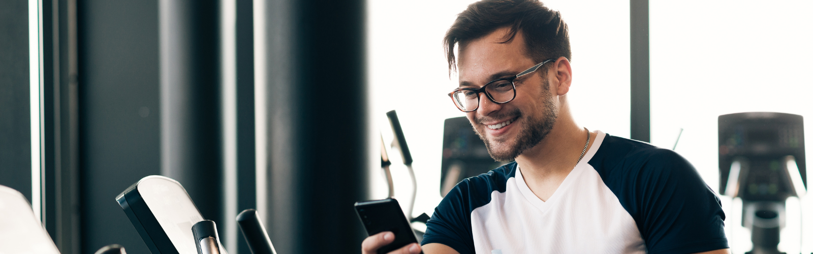 Guy on phone in gym Banner - Reduced Res