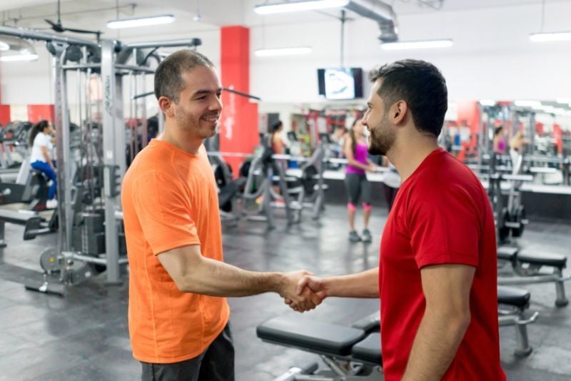 2 people in a gym shaking hands