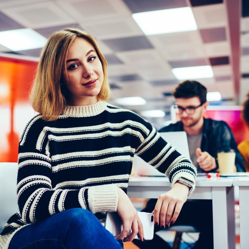 Student with mobile at a desk